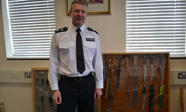 Hackney's borough commander in his office at Stoke Newington Police Station - with a cabinet of knives taken off the streets