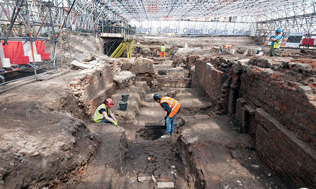 Archeologists excavating the site of The Curtain Theatre
