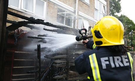 A fire fighter tackles yesterday's blaze in De Beauvoir. Photograph: Eleonore de Bonneval