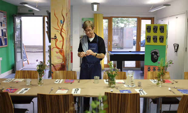 Silver service: Headway East London member Daniel hard at work setting up for one of their popular supper clubs. Photograph: Headway East London