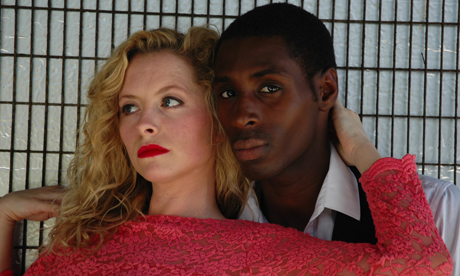 Mia Austen (Jane Larry) and Jospeh Adelakun (Compere & Saxophone), In a publicity picture for In The Jungle of Cities by Bertolt Brecht